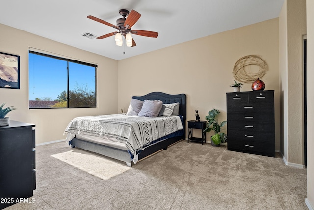 carpeted bedroom featuring baseboards, visible vents, and ceiling fan