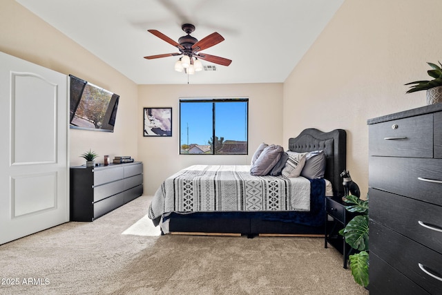 carpeted bedroom with visible vents and a ceiling fan