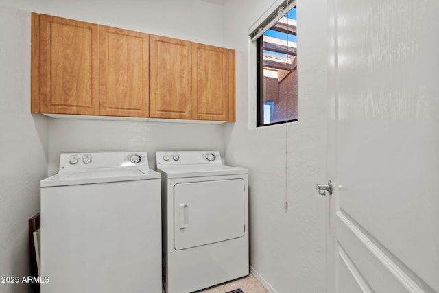 laundry area with cabinet space, baseboards, and separate washer and dryer