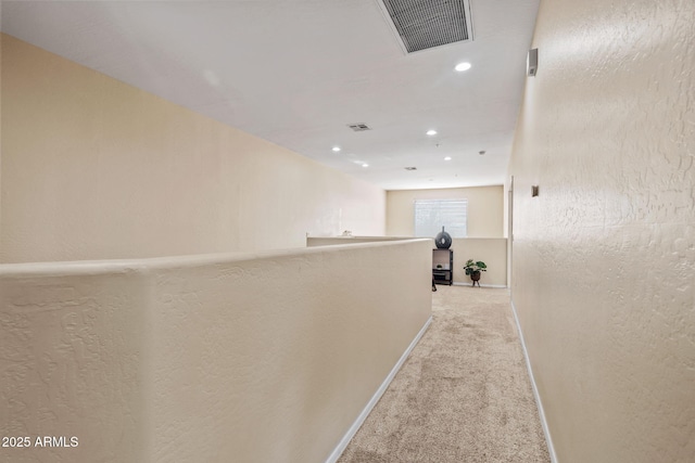 hall featuring recessed lighting, baseboards, visible vents, and light carpet