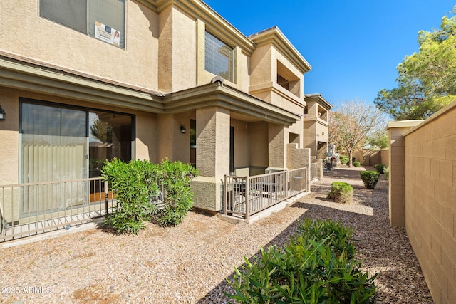 back of property featuring a patio, fence, and stucco siding