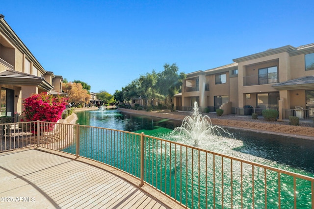 view of swimming pool featuring a residential view and a water view