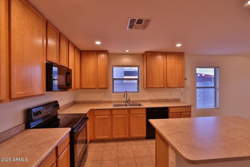 kitchen featuring recessed lighting, visible vents, a sink, and black appliances