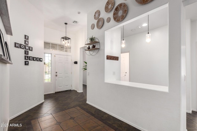 entrance foyer with dark tile patterned flooring, baseboards, recessed lighting, and visible vents