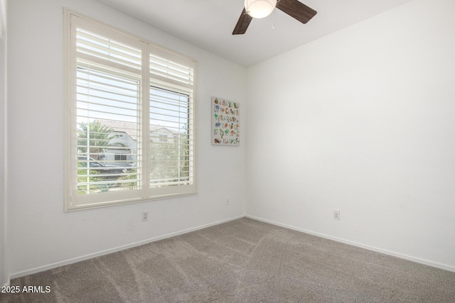 unfurnished room with carpet flooring, ceiling fan, baseboards, and a healthy amount of sunlight