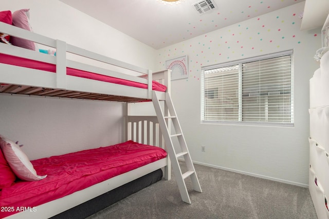 carpeted bedroom featuring baseboards and visible vents