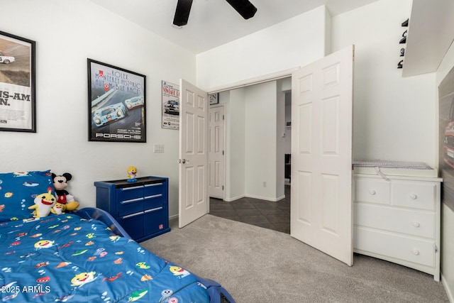 carpeted bedroom with ceiling fan and tile patterned floors