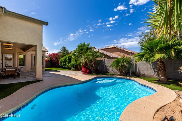 view of swimming pool featuring a patio, a fenced in pool, and a fenced backyard
