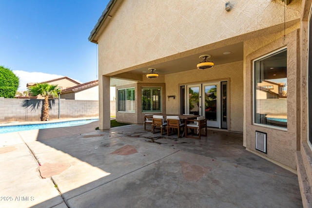 view of patio / terrace with a fenced in pool, a fenced backyard, and french doors