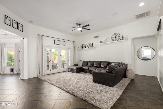 living area featuring a ceiling fan, baseboards, and visible vents