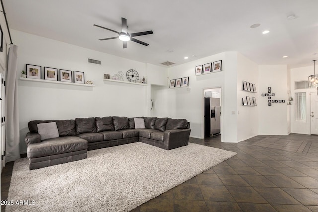 living area with recessed lighting, visible vents, and ceiling fan with notable chandelier