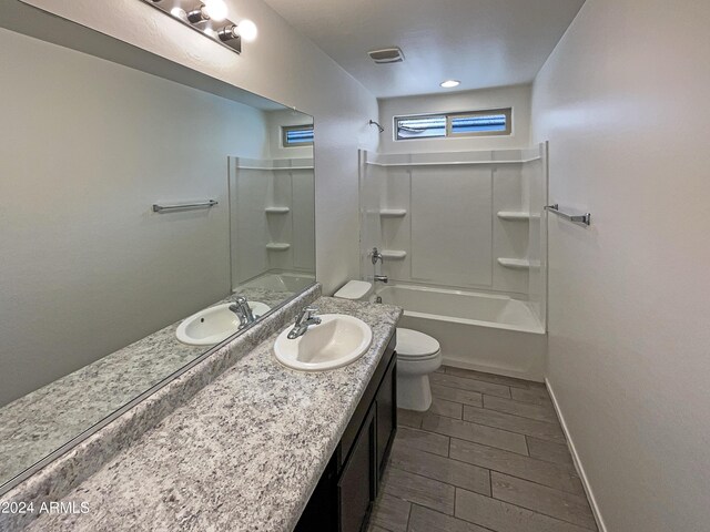 full bathroom with tile patterned flooring, washtub / shower combination, vanity, and toilet