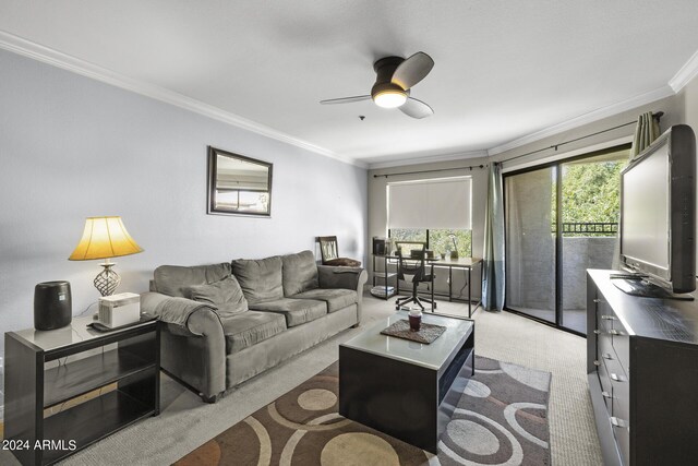 carpeted living room featuring ceiling fan and ornamental molding