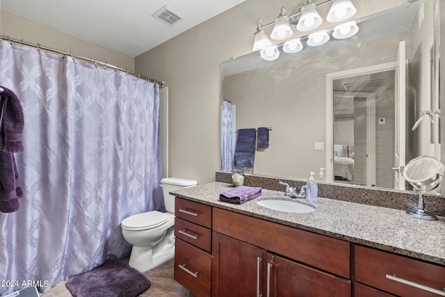 bathroom featuring a shower with curtain, vanity, and toilet