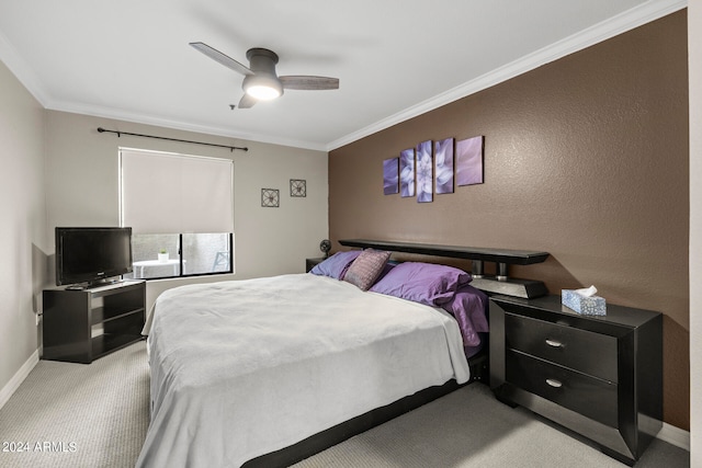 carpeted bedroom with ornamental molding and ceiling fan