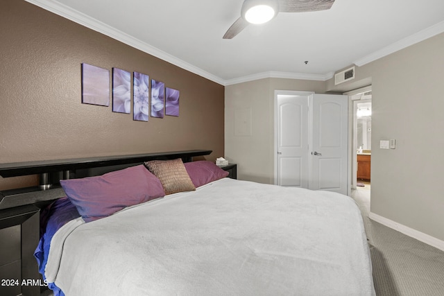 carpeted bedroom with ceiling fan and crown molding