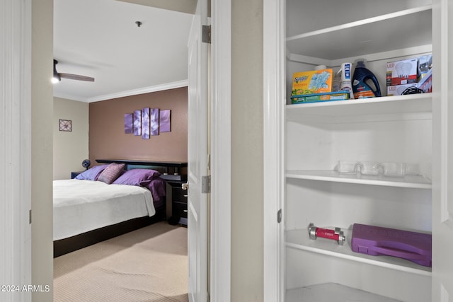 carpeted bedroom featuring ceiling fan and ornamental molding