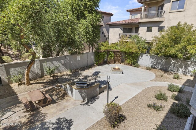 2025 E Campbell Ave Unit 260, Phoenix, AZ 85016 - view of patio featuring a fenced backyard and a fire pit