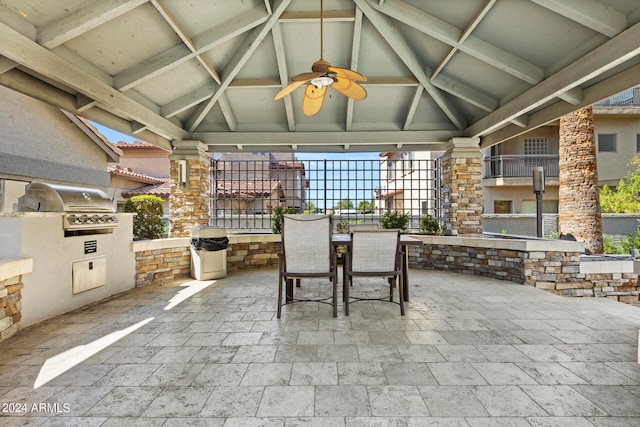 view of patio with ceiling fan, area for grilling, and exterior kitchen