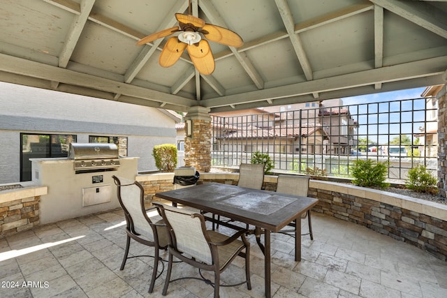 view of patio with area for grilling, ceiling fan, and a grill