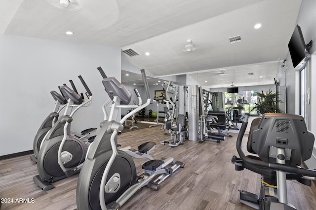 workout area with hardwood / wood-style flooring and lofted ceiling