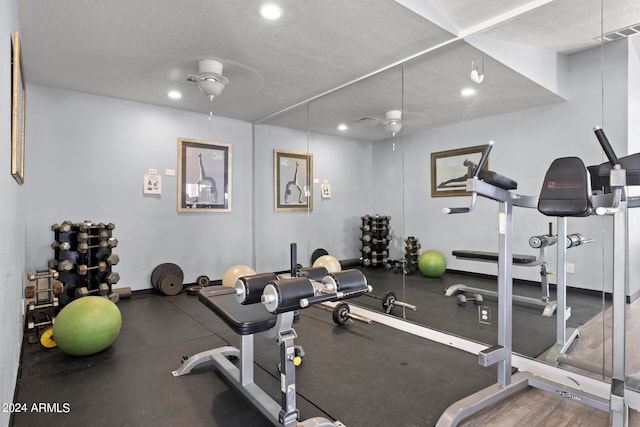 exercise room featuring a textured ceiling