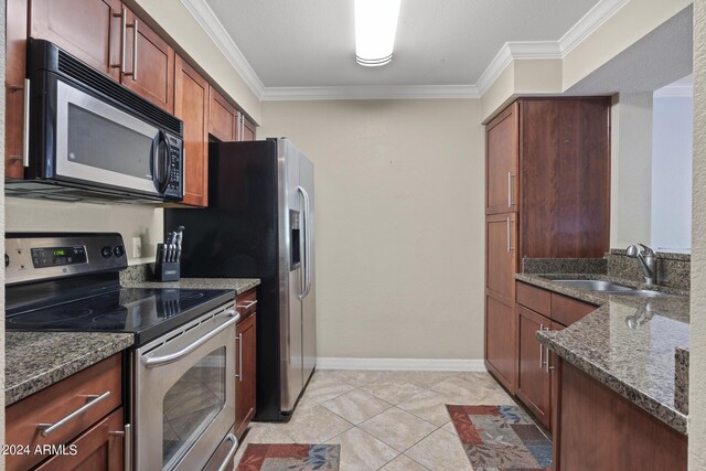 2025 E Campbell Ave Unit 260, Phoenix, AZ 85016 - kitchen with crown molding, baseboards, dark stone counters, stainless steel appliances, and a sink