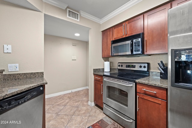 kitchen featuring stainless steel appliances, dark stone countertops, light tile patterned flooring, and crown molding