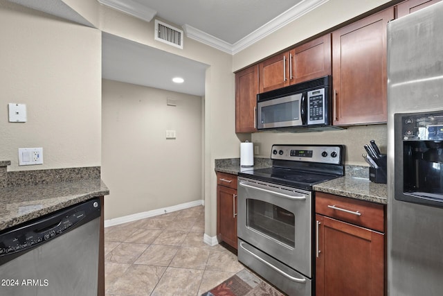 2025 E Campbell Ave Unit 260, Phoenix, AZ 85016 - kitchen featuring dark stone countertops, stainless steel appliances, baseboards, visible vents, and ornamental molding