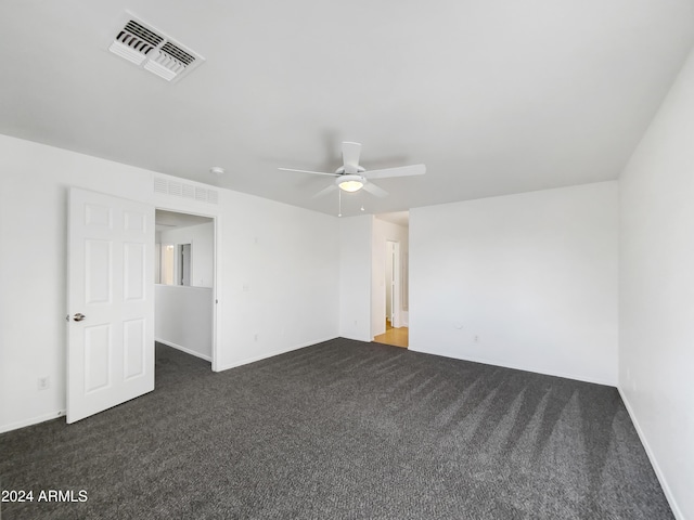 unfurnished room featuring dark colored carpet and ceiling fan