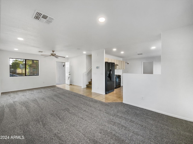 unfurnished living room with ceiling fan and light carpet