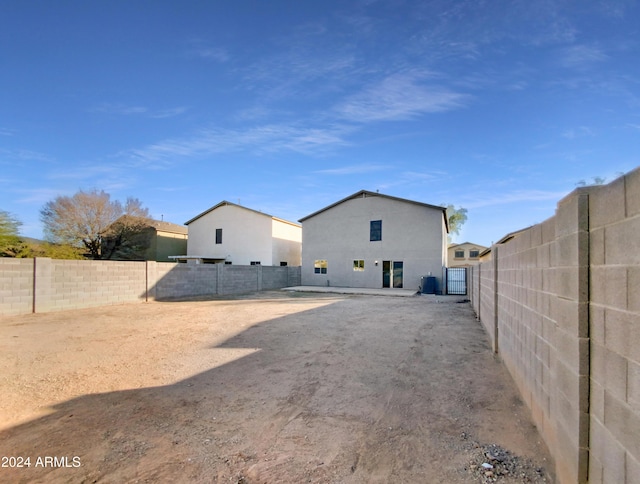 back of house featuring central air condition unit