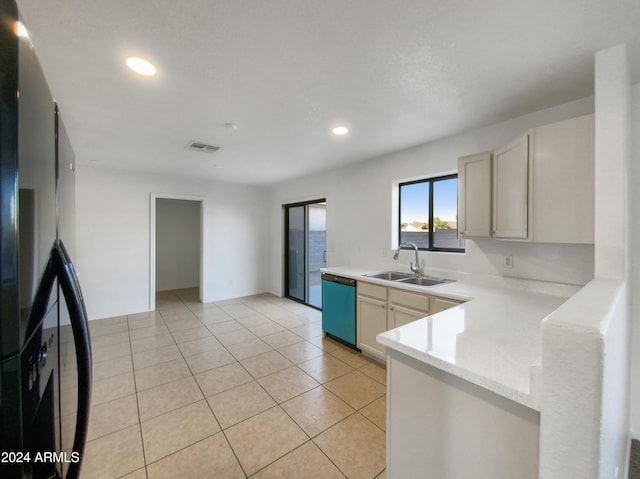 kitchen featuring stainless steel dishwasher, light tile patterned floors, sink, and fridge