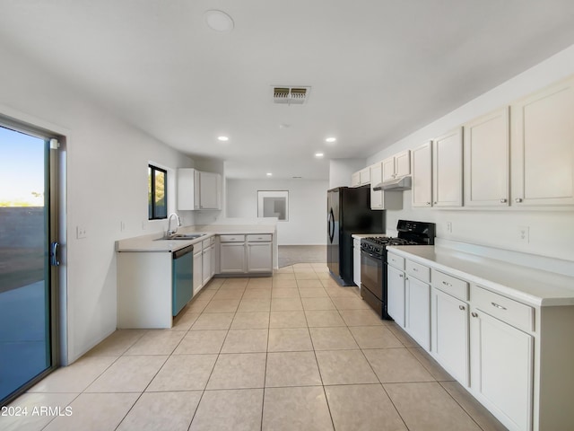 kitchen with white cabinetry, a wealth of natural light, light tile patterned flooring, and black appliances