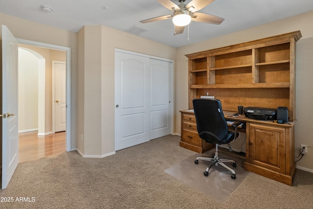 12712 W Milton Dr, Peoria, AZ 85383 - carpeted home office with a ceiling fan, arched walkways, and baseboards