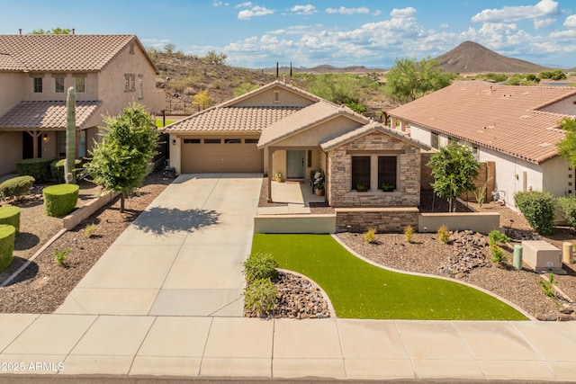 12712 W Milton Dr, Peoria, AZ 85383 - mediterranean / spanish-style house featuring concrete driveway, a mountain view, stucco siding, a garage, and a tile roof