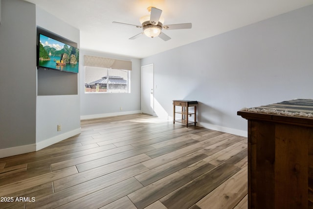 spare room with light hardwood / wood-style floors and ceiling fan