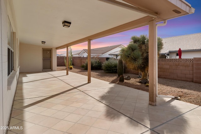 view of patio terrace at dusk