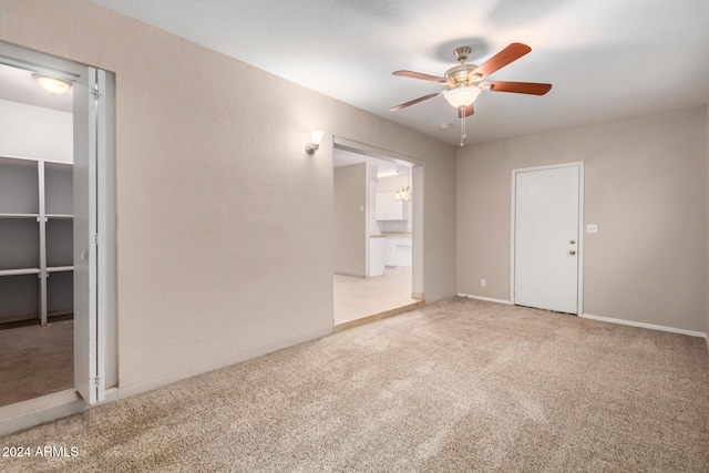 unfurnished room with light carpet and ceiling fan