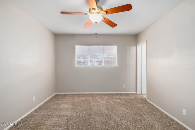 spare room with ceiling fan and carpet