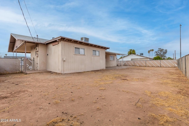 rear view of house featuring central AC unit