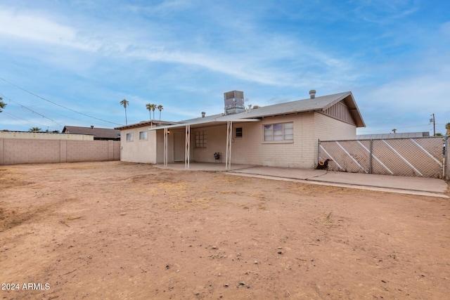 rear view of house featuring central AC unit and a patio