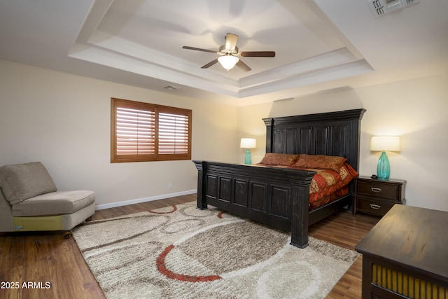 11447 E Mendoza Ave, Mesa, AZ 85209 - bedroom with visible vents, wood finished floors, baseboards, ceiling fan, and a tray ceiling