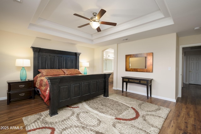 11447 E Mendoza Ave, Mesa, AZ 85209 - bedroom featuring arched walkways, baseboards, wood finished floors, a tray ceiling, and visible vents