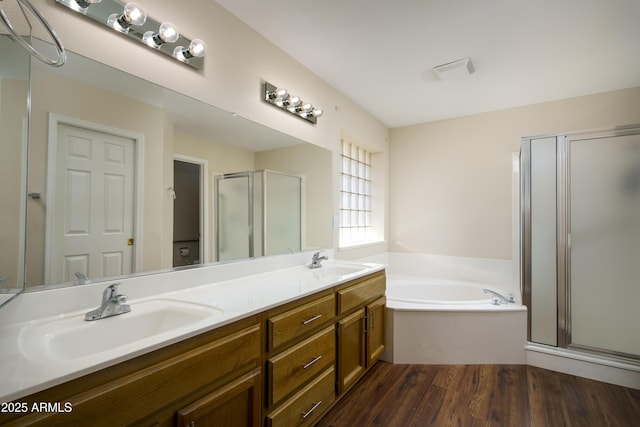 11447 E Mendoza Ave, Mesa, AZ 85209 - full bath with double vanity, a bath, a shower stall, wood finished floors, and a sink