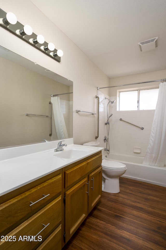 11447 E Mendoza Ave, Mesa, AZ 85209 - bathroom with visible vents, vanity, wood finished floors, shower / bath combination with curtain, and toilet