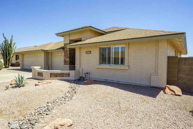 11447 E Mendoza Ave, Mesa, AZ 85209 - view of front of property featuring a garage, fence, stucco siding, and driveway