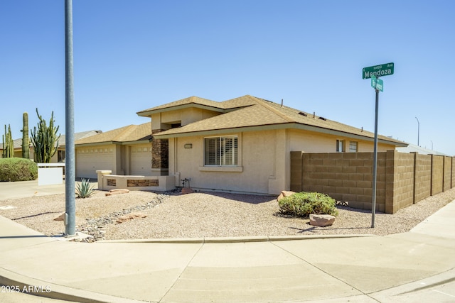 11447 E Mendoza Ave, Mesa, AZ 85209 - view of front of house featuring fence, roof with shingles, stucco siding, an attached garage, and driveway