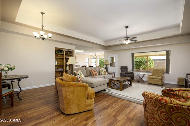11447 E Mendoza Ave, Mesa, AZ 85209 - living area featuring baseboards, a raised ceiling, ceiling fan with notable chandelier, and wood finished floors