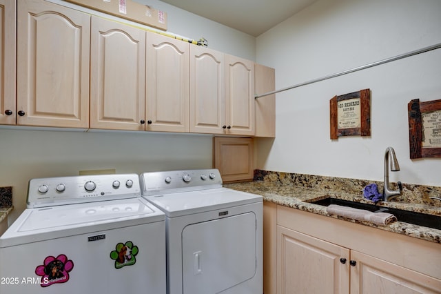 washroom featuring a sink, cabinet space, and independent washer and dryer